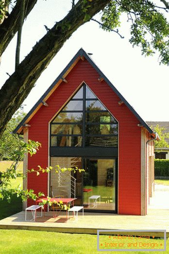 Унутрашњост мале дрвене куће са великим прозорима